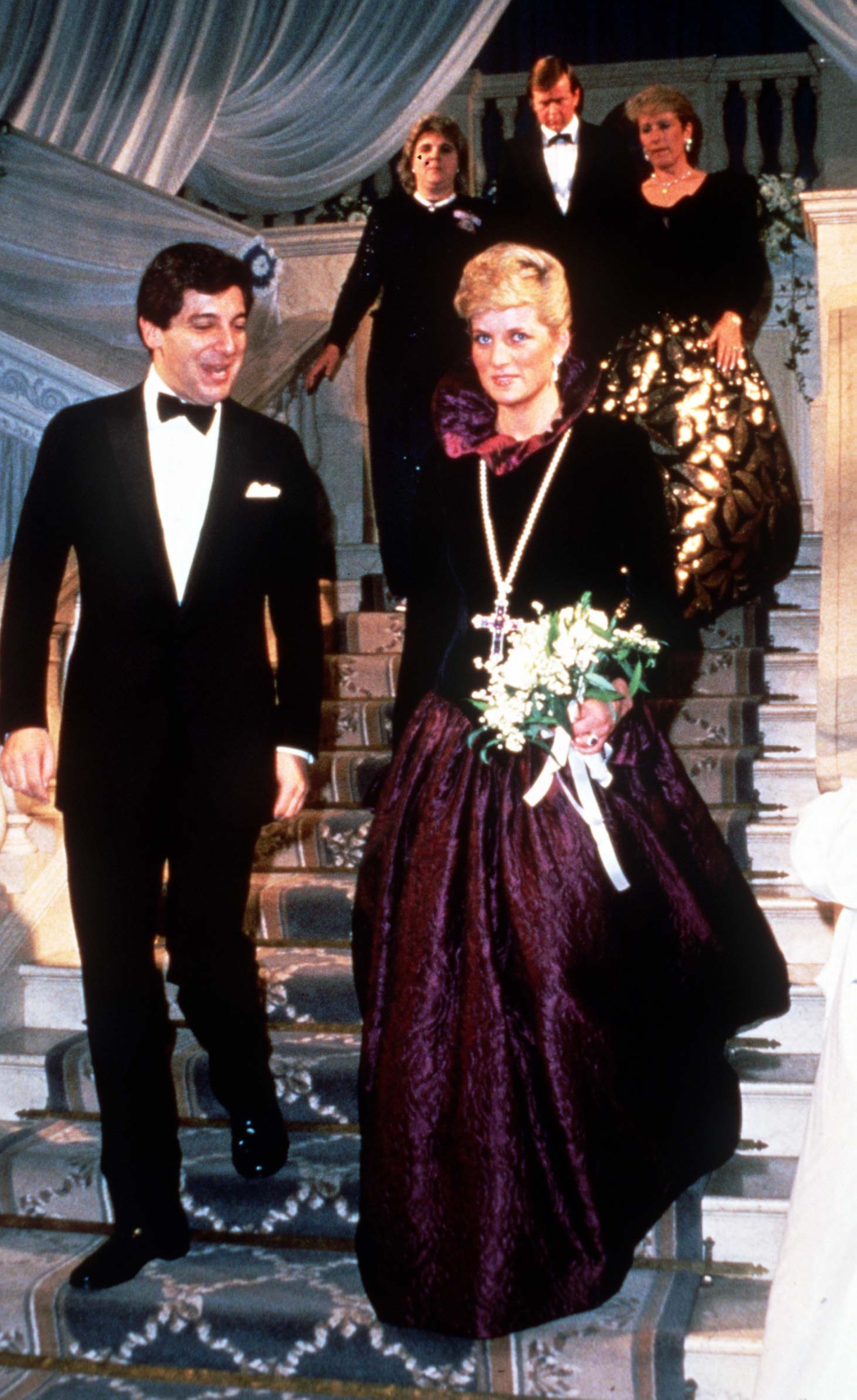 Diana, Princess of Wales, wearing a long purple Catherine Walker evening gown, attends a charity evening on behalf of Birthright at Garrard the Jewellers, London, U.K., Oct. 27, 1987. (Getty Images Photo)