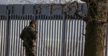 A Greek Army officer walks next to a border fence, built to prevent migrant crossings, during a press tour at the Greek-Turkish border, near the village of Poros, Evros region, Greece, Jan. 21, 2023. (REUTERS Photo)