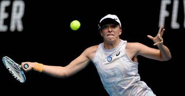 Poland's Iga Swiatek hits a return against Kazakhstan's Elena Rybakina during their women's singles match on day seven of the Australian Open tennis tournament, Melbourne, Australia, Jan. 22, 2023. (AFP Photo)
