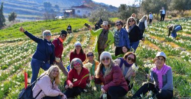 People pose at the Daffodil Festival held for the first time in Tarsus, Mersin, Türkiye, Jan. 22, 2023. (IHA Photo)