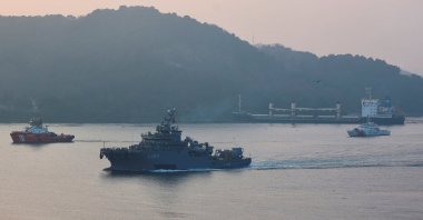 The Turkish navy's rescue ship TCG Işın sails in the Bosporus as the Palau-flagged bulk carrier MKK1, carrying grain under the Black Sea grain initiative, is seen drifted aground in Istanbul, Türkiye, Jan. 16, 2023. (Reuters Photo)