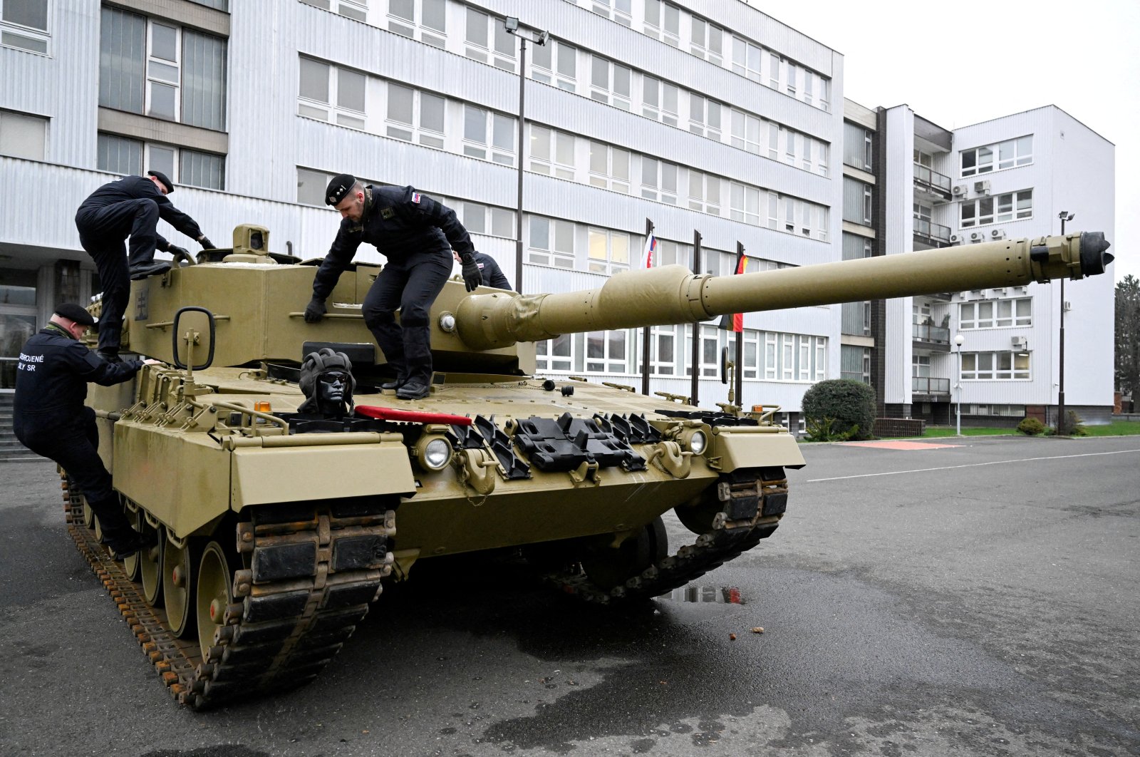 Members of the military walk on a tank, as Germany delivers its first Leopard tanks to Slovakia as part of a deal after Slovakia donated fighting vehicles to Ukraine, in Bratislava, Slovakia, Dec. 19, 2022. (Reuters Photo)