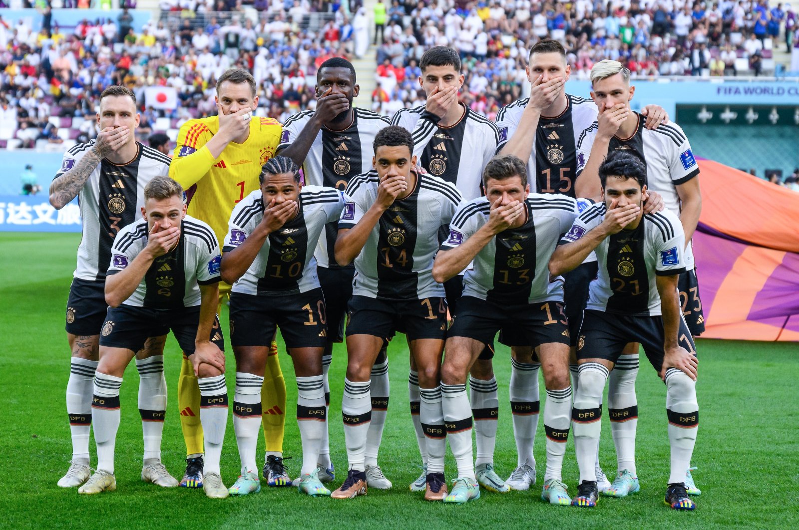Germany players cover their mouths in protest as they pose for a team photo prior to the World Cup match against Japan at Khalifa International Stadium, Doha, Qatar, Nov. 23, 2022. (Getty Images photo)