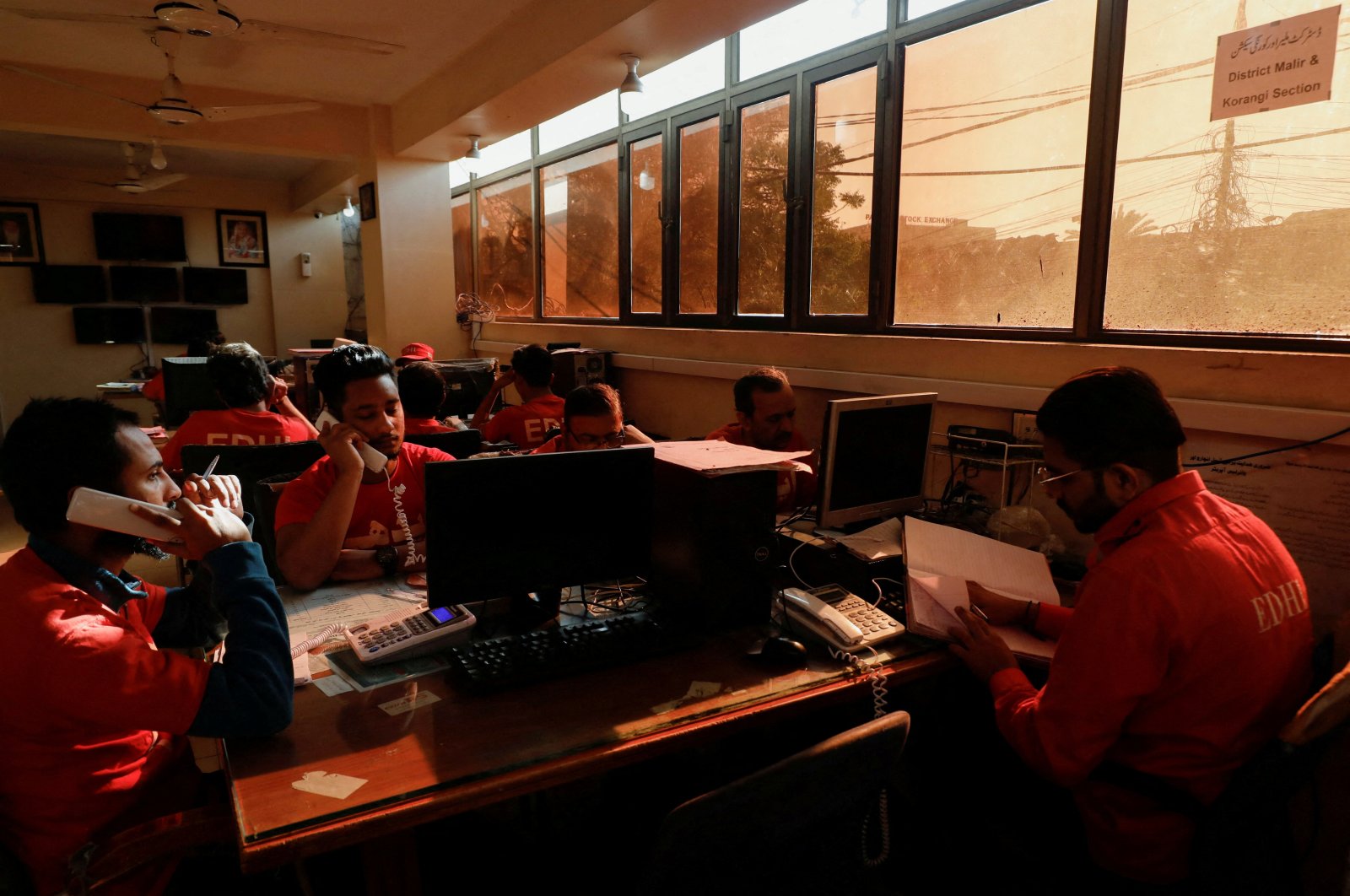 People work at an office during a country-wide power breakdown, Karachi, Pakistan, Jan. 23, 2023. (Reuters Photo)