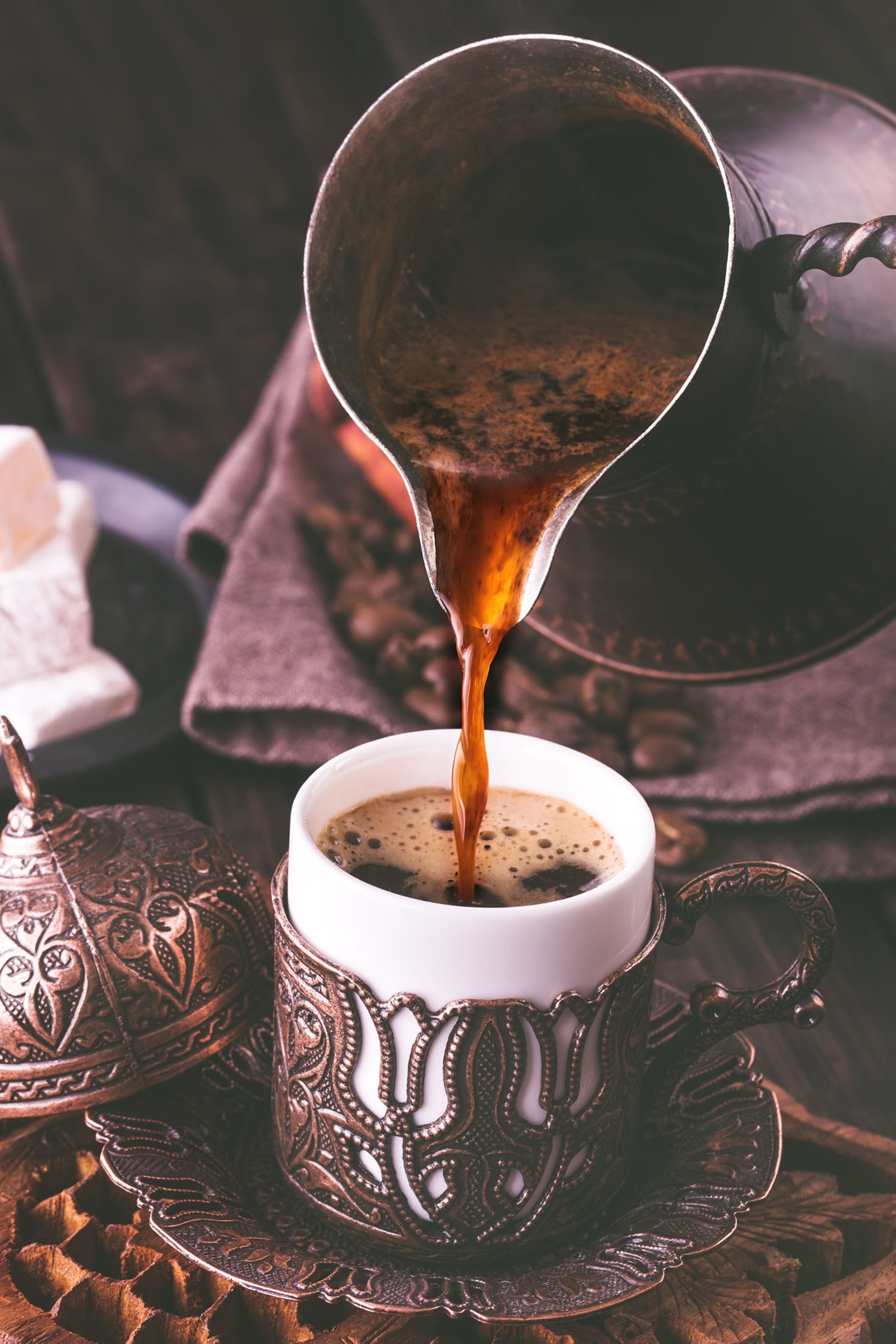 Turkish coffee poured into a traditional embossed metal cup. (Shutterstock Photo)