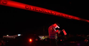 A San Mateo County sheriff deputy stands at the scene of a shooting on Highway 92 in Half Moon Bay, California, U.S., Jan. 23, 2023. (AFP Photo)