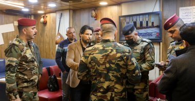 Iraqi security forces check people during a security operation to arrest Dollar manipulators in Baghdad, Iraq, January 22, 2023. REUTERS/Ahmed Saad