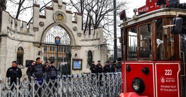 Turkish riot police stand guard before a protest while a nostalgic tram passes in front of the Consulate General of Sweden, in Istanbul, Türkiye, Jan. 22, 2023. (EPA Photo)