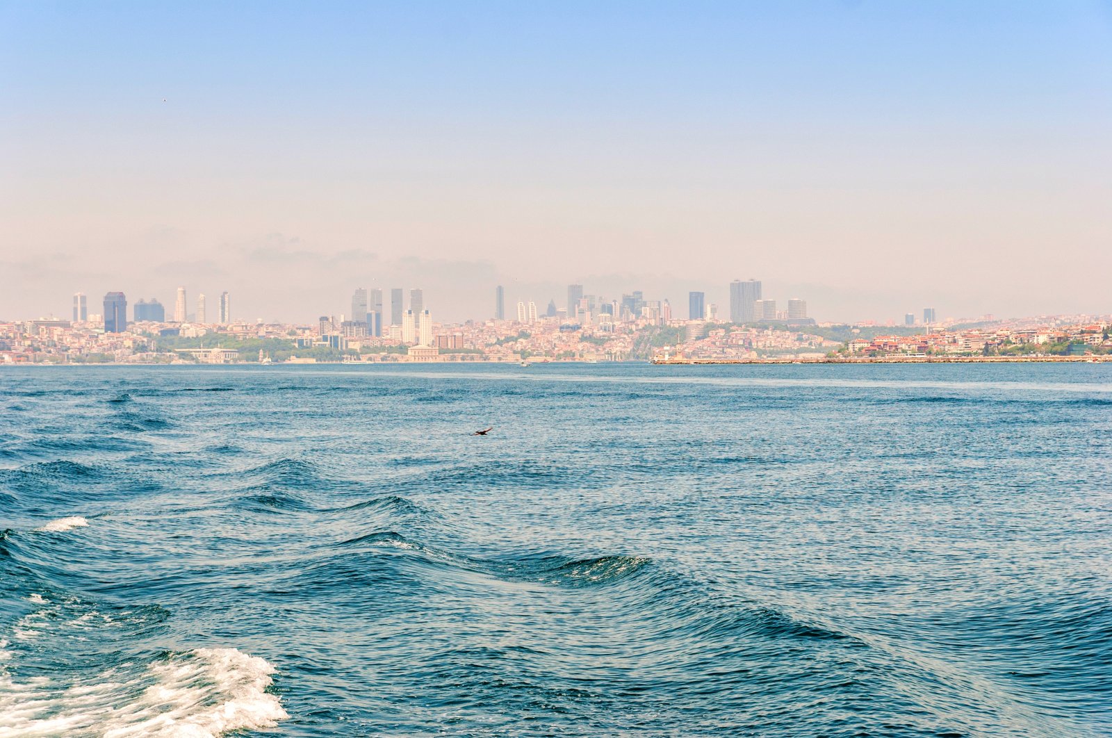 A general view of the Marmara Sea backdropped by skyscrapers in the business center of Istanbul, Türkiye. (Shutterstock Photo)