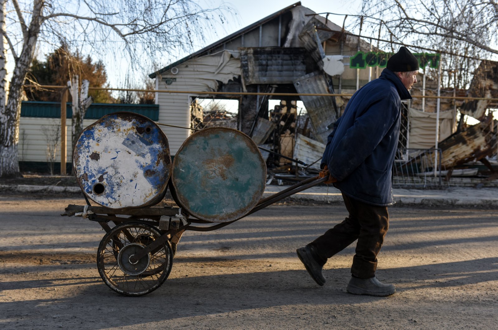 A local transports barrels on a cart in Siversk, Donetsk region, eastern Ukraine, Jan. 23, 2023. (EPA Photo)