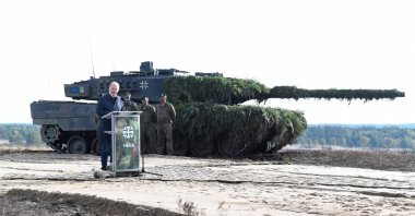 German Chancellor Olaf Scholz delivers a speech in front of a Leopard 2 tank during a visit to a military base of the German army Bundeswehr in Bergen, Germany, Oct. 17, 2022. (Reuters Photo)