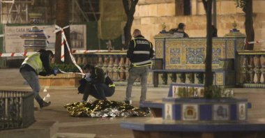 Police work next to the body of a man killed in Algeciras, southern Spain, Wednesday, Jan. 25, 2023. (AP Photo)