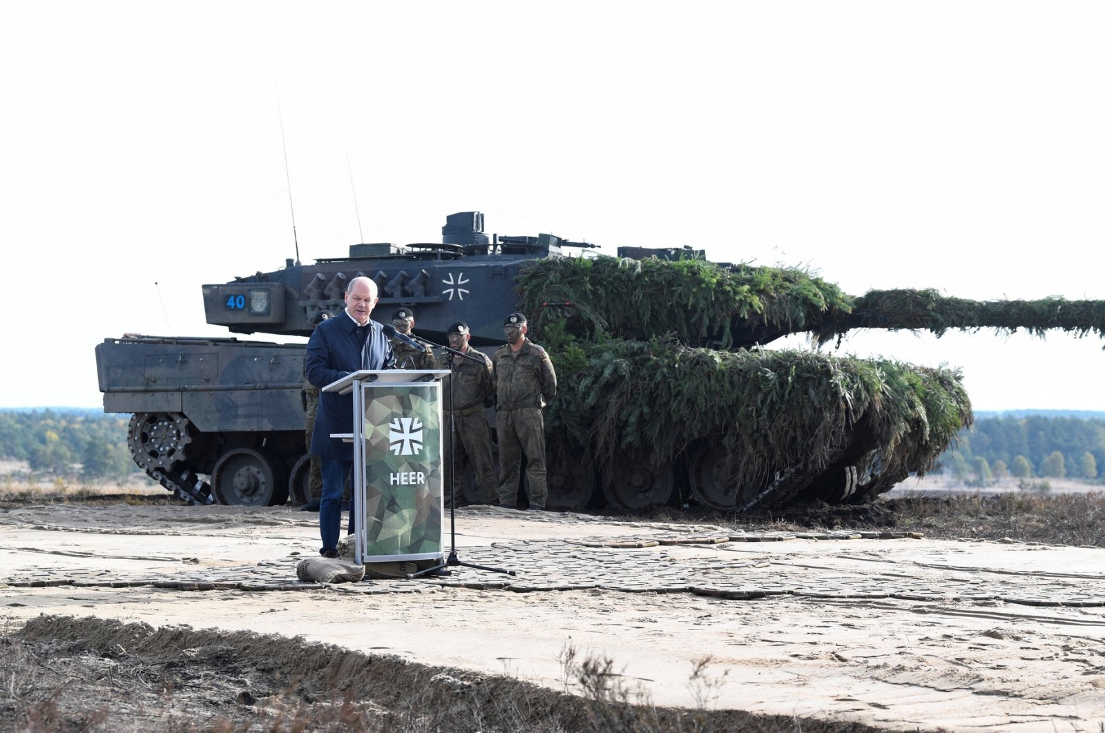 German Chancellor Olaf Scholz delivers a speech in front of a Leopard 2 tank during a visit to a military base of the German army Bundeswehr in Bergen, Germany, Oct. 17, 2022. (Reuters Photo)