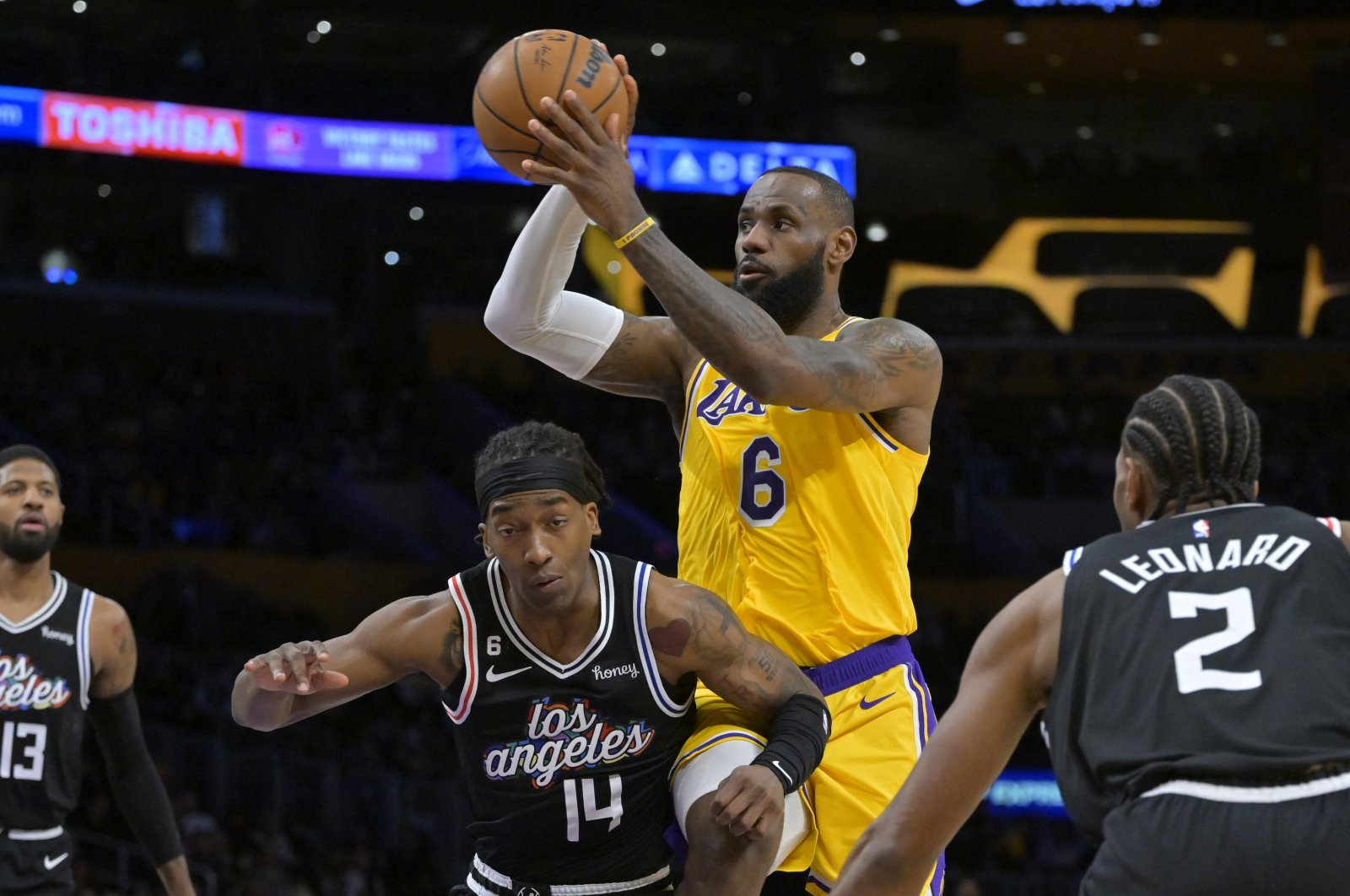 Los Angeles Lakers forward LeBron James (R2) passes the ball over Los Angeles Clippers guard Terance Mann (L2) as guard Paul George (L) and forward Kawhi Leonard (R) look on in the first quarter at Crypto.com Arena, Los Angeles, California, USA, Jan 24, 2023. (Reuters Photo)