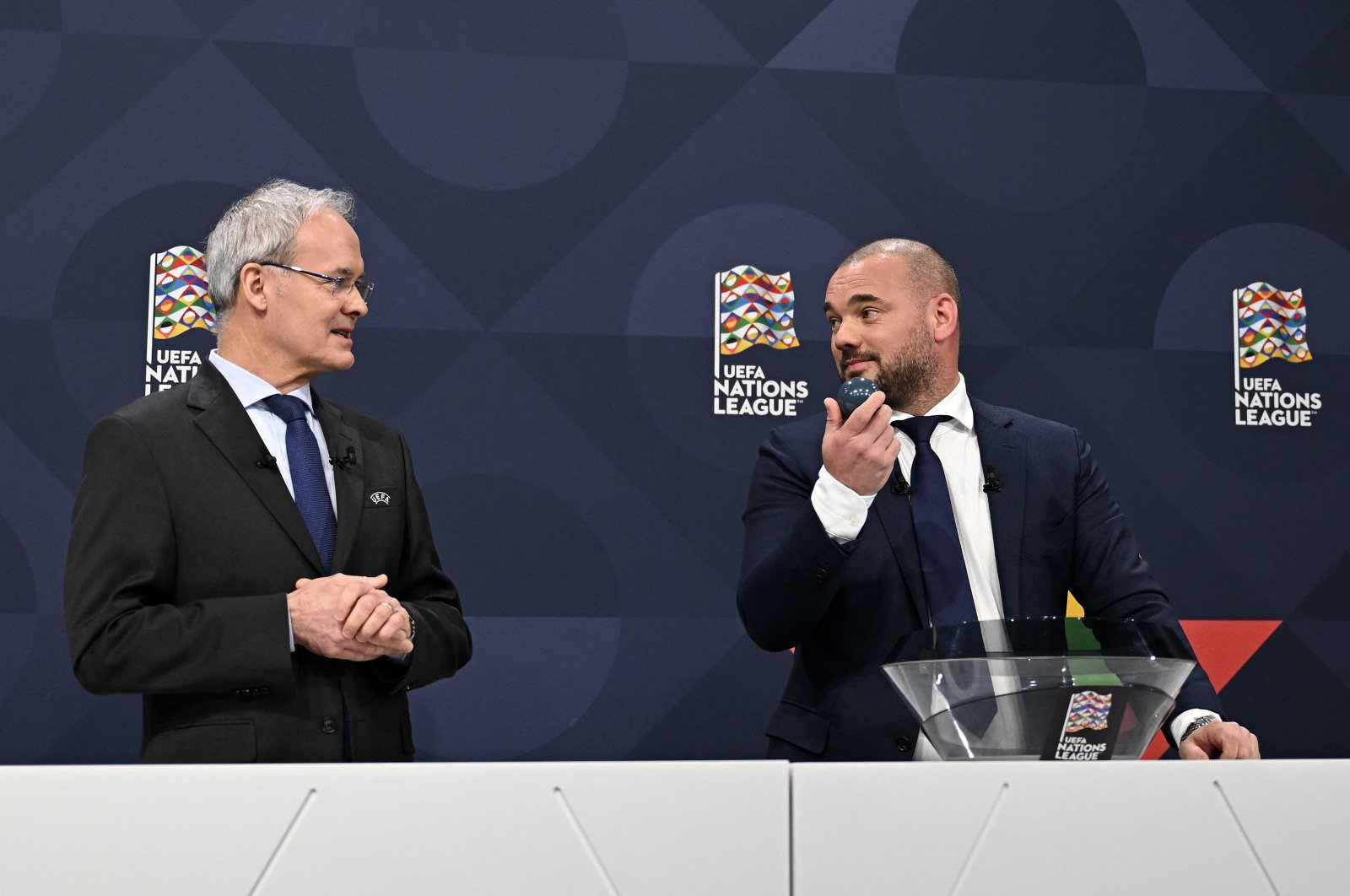 Dutch Wesley Sneijder (R) looks at UEFA director of competitions Giorgio Marchetti (L) during the 2023 UEFA Nations League football finals draw, Nyon, Switzerland, Jan. 25, 2023. (AFP Photo)