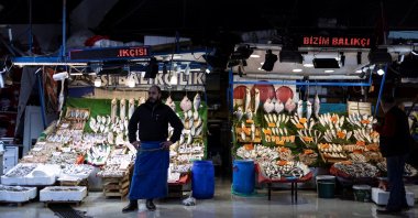 A fish market owner in front of his store in Istanbul, Türkiye, Jan. 19, 2023. (Reuters Photo)