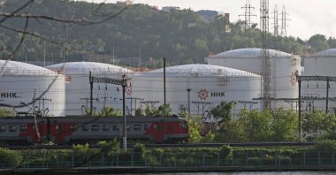 A train moves past oil tanks of the NNK-Primornefteproduct petroleum depot in the far eastern port of Vladivostok, Russia, June 11, 2022. (Reuters Photo)