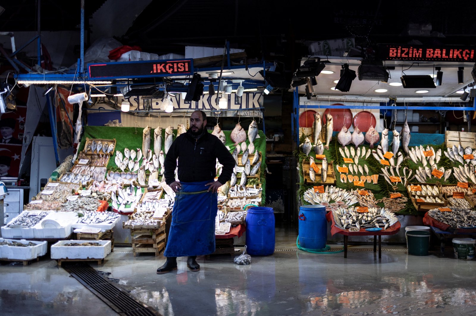 A fish market owner in front of his store in Istanbul, Türkiye, Jan. 19, 2023. (Reuters Photo)