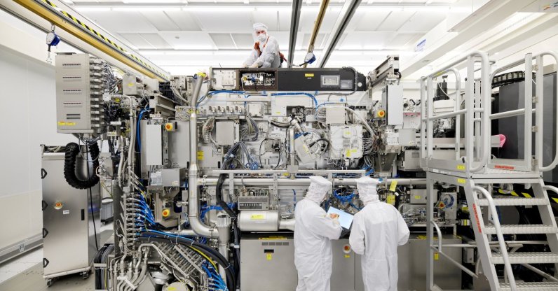 Employees working on the final assembly of ASML's TWINSCAN NXE:3400B semiconductor lithography tool with its panels removed, in Veldhoven, Netherlands, April 4, 2019. (Reuters Photo)