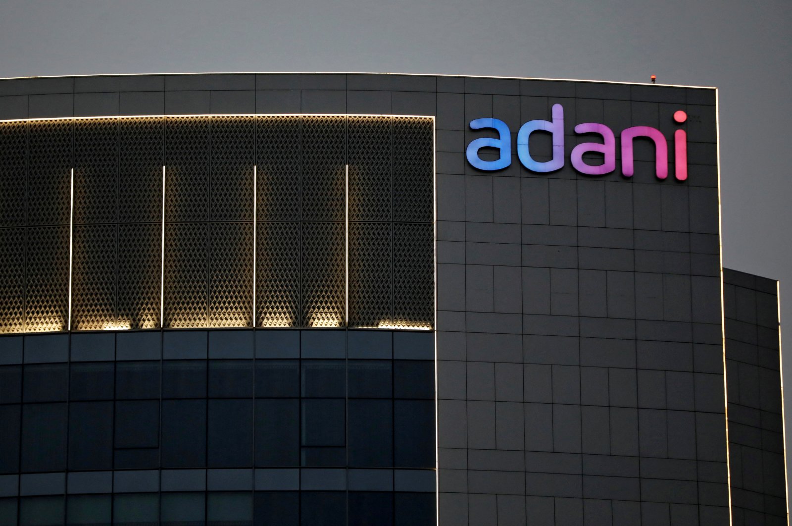 The logo of the Adani Group is seen on the facade of one of its buildings on the outskirts of Ahmedabad, India, April 13, 2021. (Reuters Photo)
