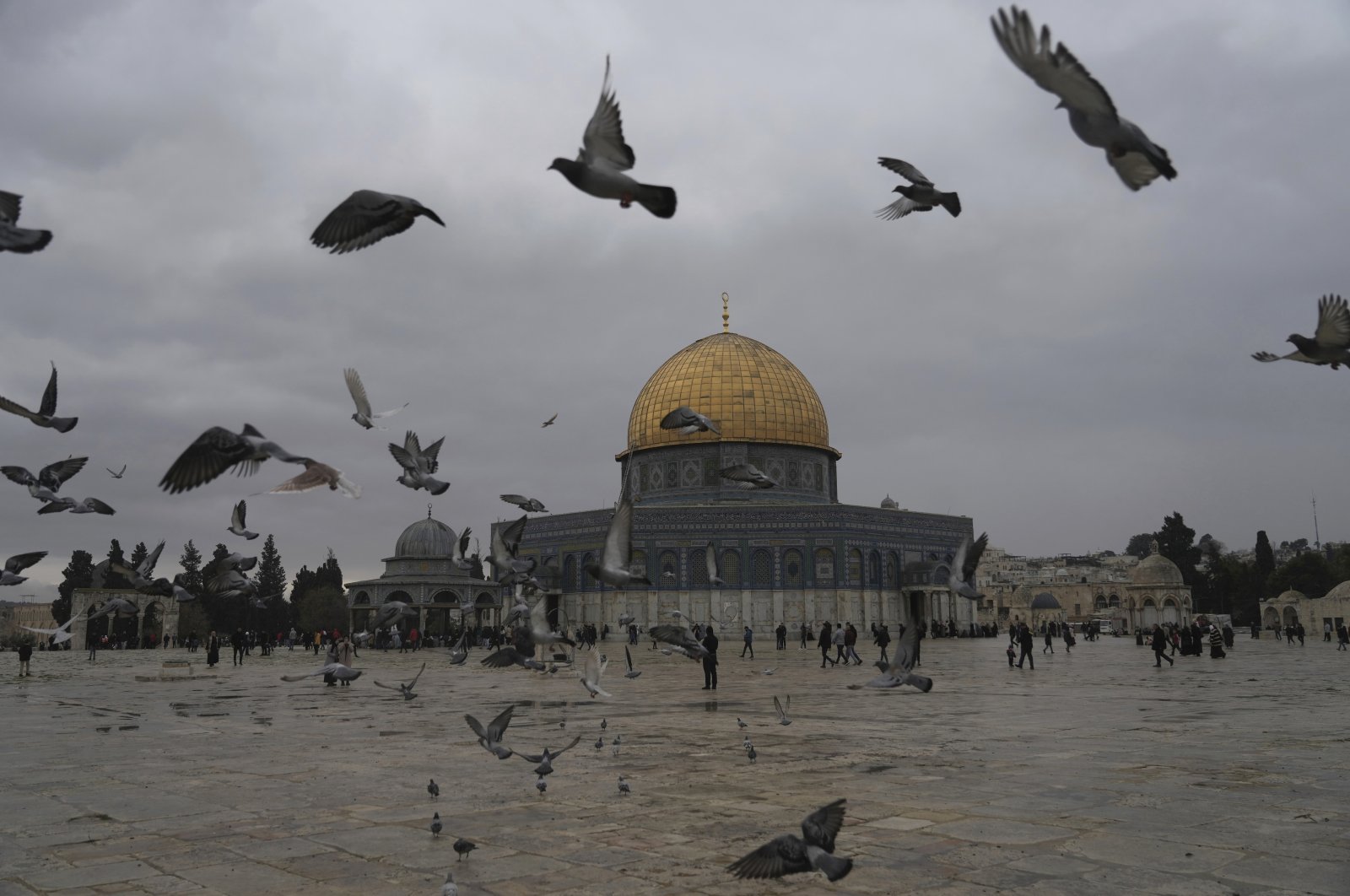 Birds fly near the Dome of the Rock Mosque in the Al-Aqsa Mosque compound in the Old City as worshippers gather for Friday prayers on a cold, rainy day at the Al-Aqsa Mosque compound in the  Israeli-occupied Jerusalem, Palestine, Jan. 6, 2023. (AP Photo)