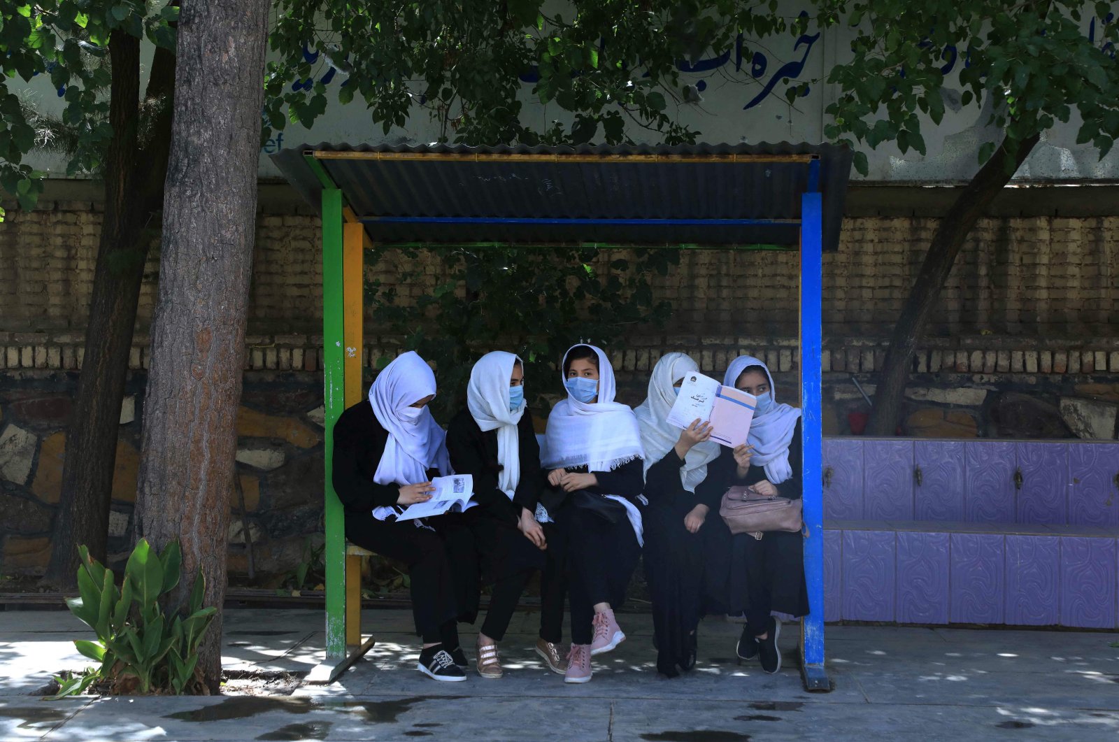 Schoolgirls sit at the schoolyard in Herat, following the Taliban&#039;s takeover of the country, Aug. 17, 2021. (AFP File Photo)