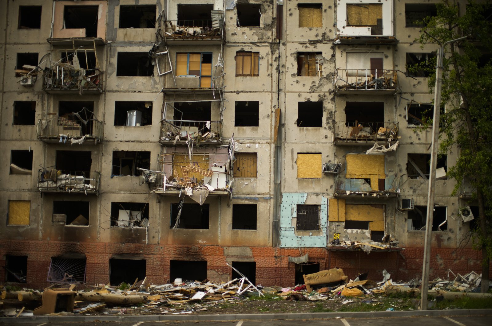 Debris hangs from a residential building heavily damaged in a Russian bombing earlier in the war in Kramatorsk, eastern Ukraine, Saturday, May 21, 2022. (AP File Photo)