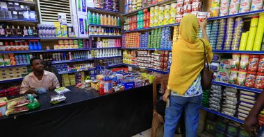 A customer chooses a food item at a grocery shop in the capital Khartoum, Sudan, Jan. 19, 2023. (AFP Photo)