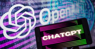 The OpenAI logo is seen on a large screen with the ChatGPT website displayed on a nearby mobile device in this illustration taken in Brussels, Belgium, Jan. 8, 2023. (Getty Images Photo)