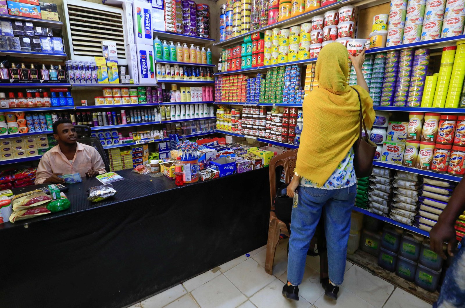 A customer chooses a food item at a grocery shop in the capital Khartoum, Sudan, Jan. 19, 2023. (AFP Photo)