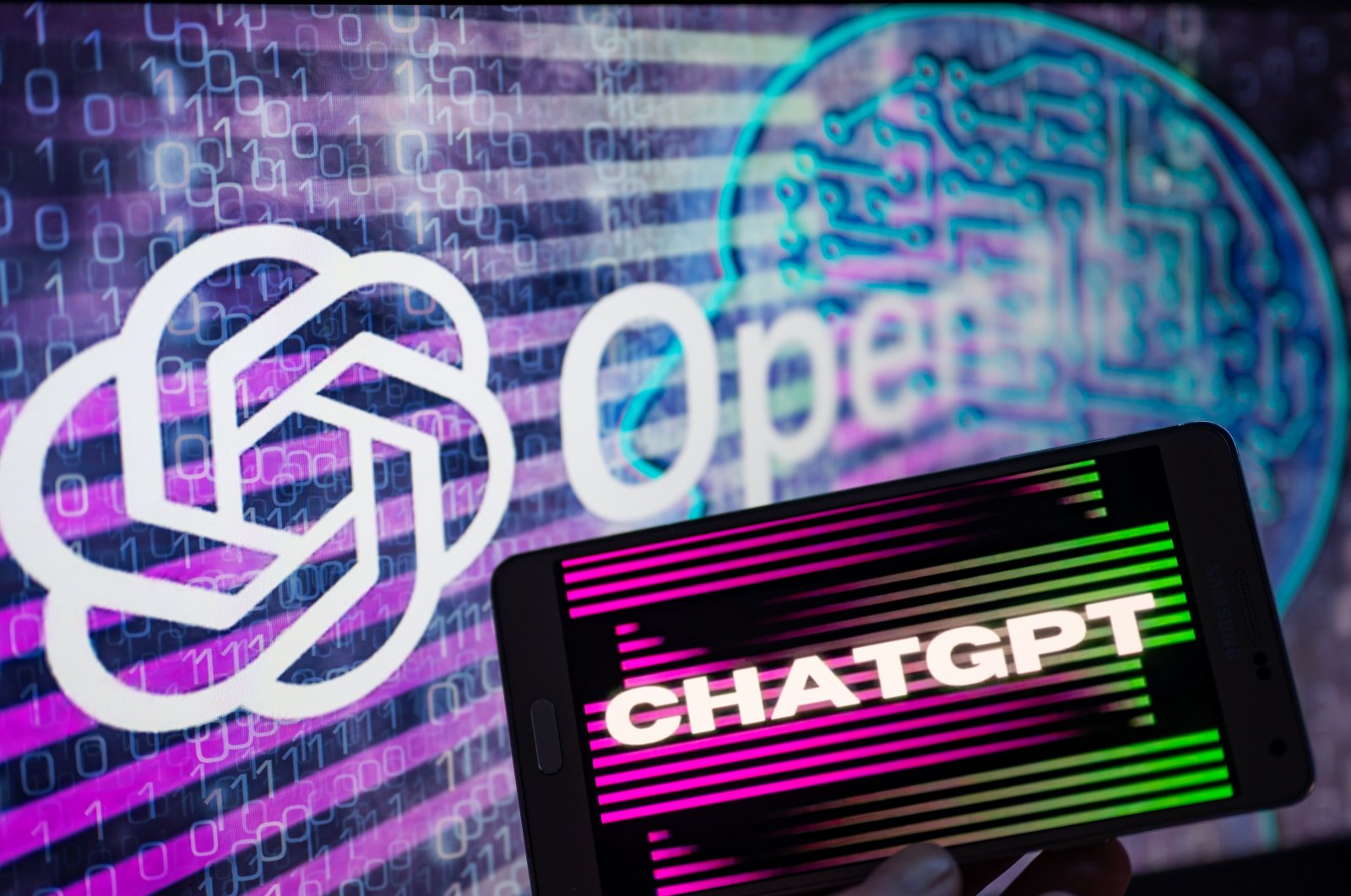 The OpenAI logo is seen on a large screen with the ChatGPT website displayed on a nearby mobile device in this illustration taken in Brussels, Belgium, Jan. 8, 2023. (Getty Images Photo)