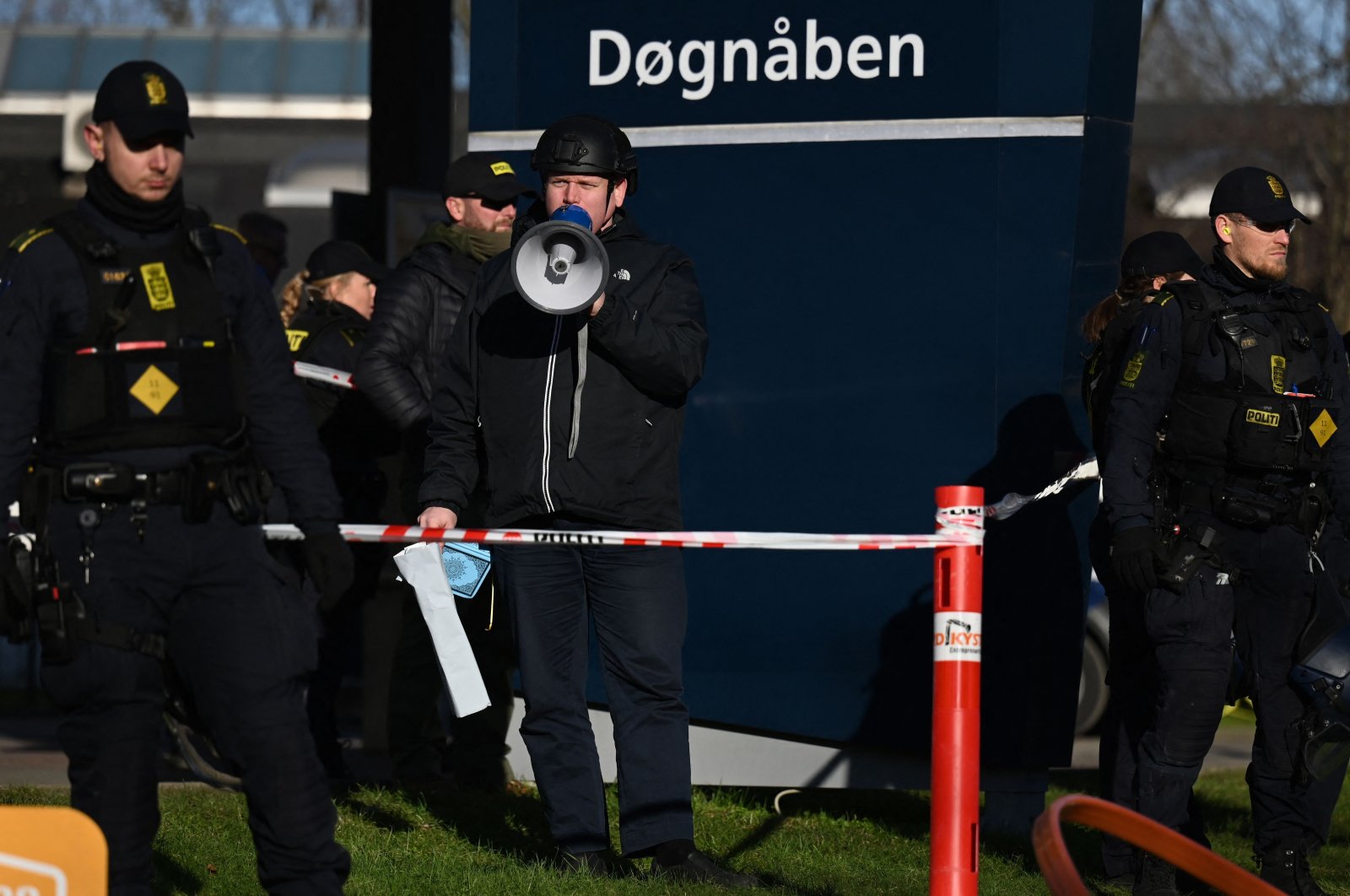 Police officers surround Rasmus Paludan as he speaks in front of a mosque in Copenhagen, Denmark, Jan. 27, 2023. (AFP Photo)