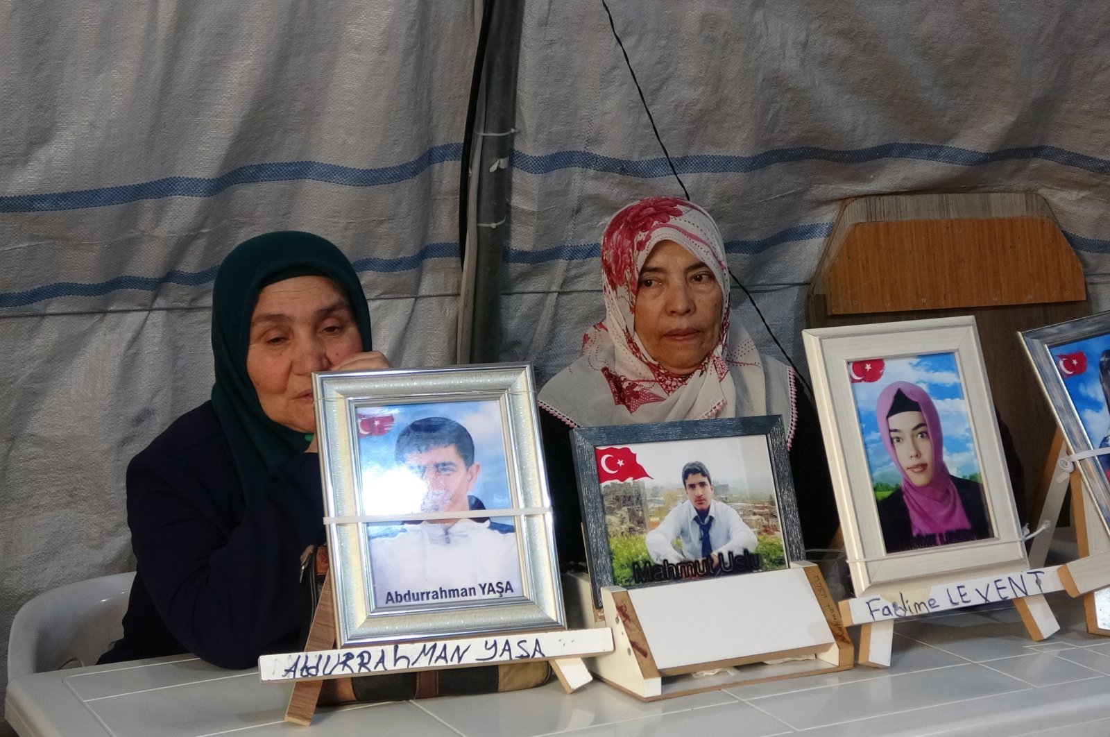 Families show photos of their children abducted by the PKK, in Diyarbakır, southeastern Türkiye, Jan. 29, 2023. (İHA Photo)