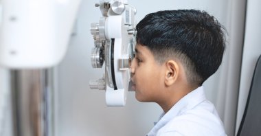 A boy sits for an examination with an optometrist. (Shutterstock Photo)