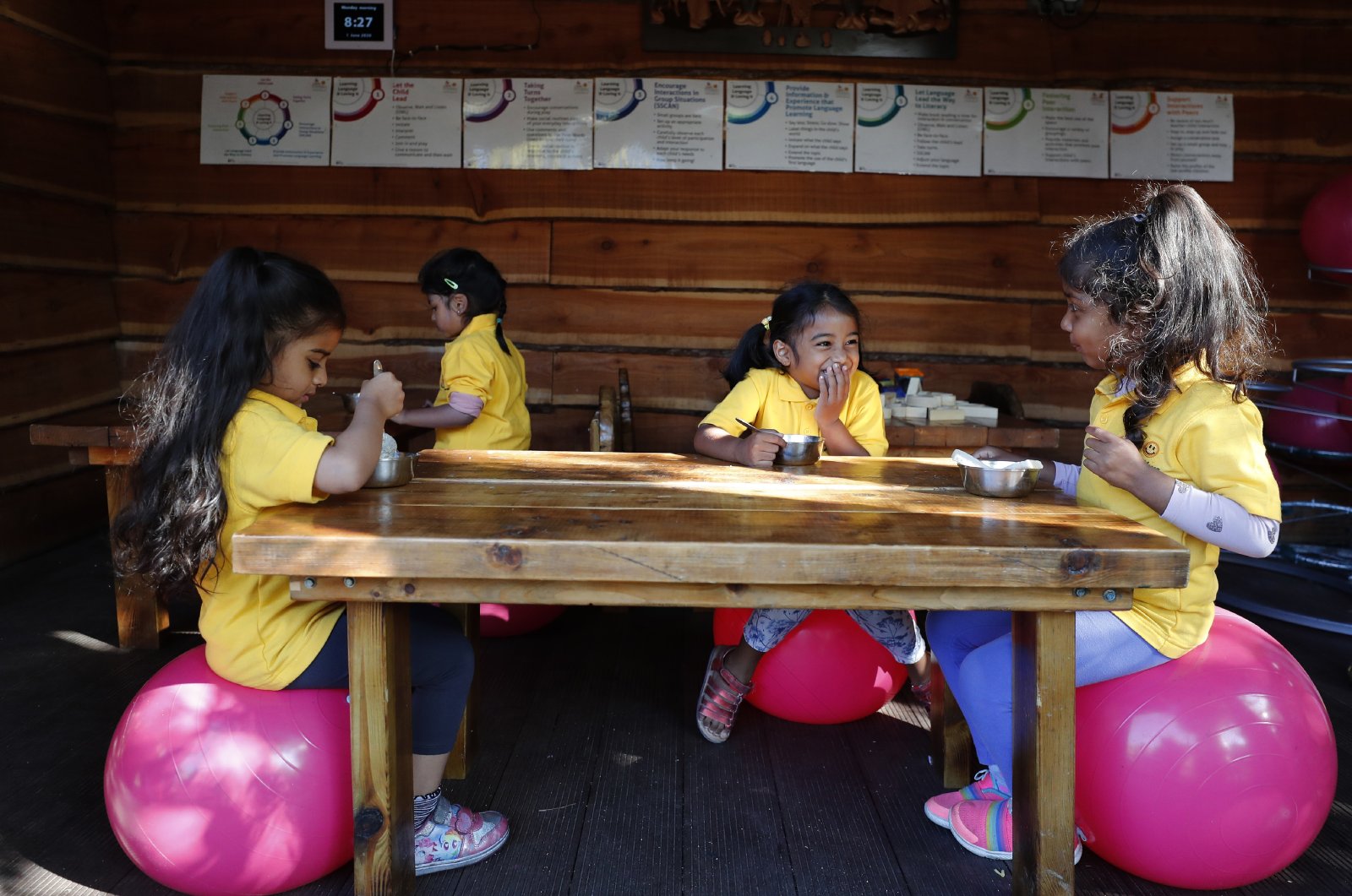 Children have breakfast at a home-based Childcare in London, U.K., June 1, 2020. (AP Photo)