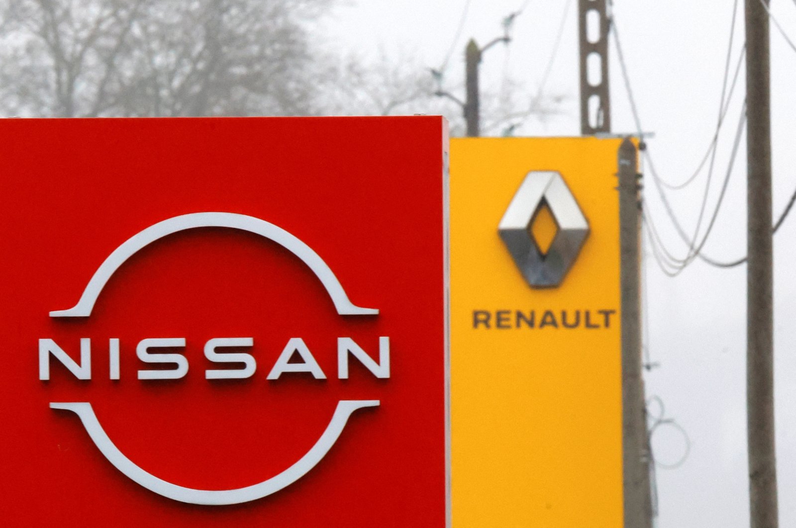 The logos of car manufacturers Nissan and Renault are seen in front of dealerships of the companies in Etampes, near Paris, France, Jan. 26, 2023. (Reuters Photo)