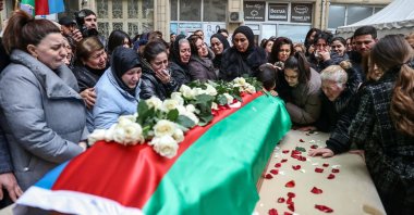 People gather around a coffin with the body of Orkhan Askerov, the security chief at Azerbaijan&#039;s embassy in Iran shot dead by a gunman in a recent attack, Baku, Azerbaijan, Jan. 30, 2023. (Reuters Photo)