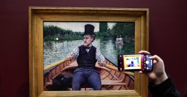 A man takes a picture of the painting &quot;La Partie de bateau&quot; by Gustave Caillebotte, classified as a &quot;national treasure,&quot; which has just joined the Musee d&#039;Orsay, Paris, France, Jan. 30, 2023. (AFP Photo)