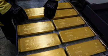An employee stores marked ingots of 99.99% pure gold on a cart at a plant in Krasnoyarsk, Russia, April 9, 2019. (Reuters Photo)