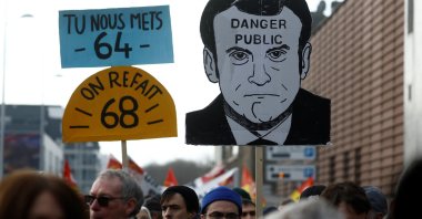 Protesters hold a placard depicting French President Emmanuel Macron, Saint-Nazaire, France, Jan. 31, 2023. (Reuters Photo)