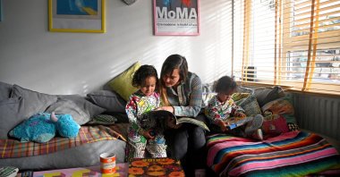 Secondary school teacher Lucy Preston reads with her sons, Sufjan and Elias, during an interview with Reuters ahead of strike action, at her home in London, Britain, Jan. 30, 2023. (Reuters Photo)