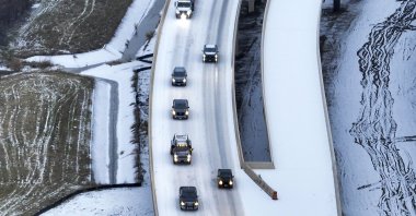 An icy mix covers Highway 114 in Roanoke, Texas. Dallas and other parts of North Texas are under a winter storm warning through Wednesday, Jan.23, 2023. (AP Photo)