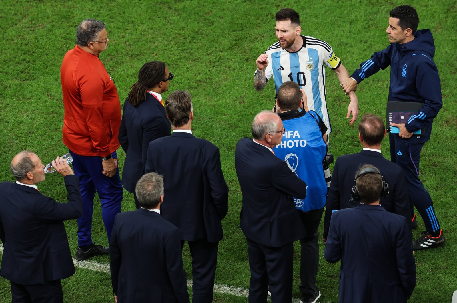 Argentina&#039;s Lionel Messi talks with assistant coach Edgar Davids and head coach Louis van Gaal of Netherlands during the FIFA World Cup Qatar 2022 quarterfinal match between Netherlands and Argentina at Lusail Stadium, Lusail City, Qatar, Dec. 9, 2022. (Getty Images Photo)