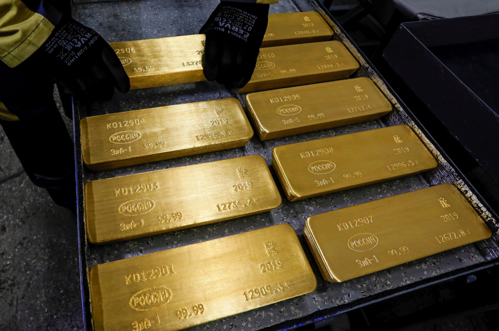 An employee stores marked ingots of 99.99% pure gold on a cart at a plant in Krasnoyarsk, Russia, April 9, 2019. (Reuters Photo)