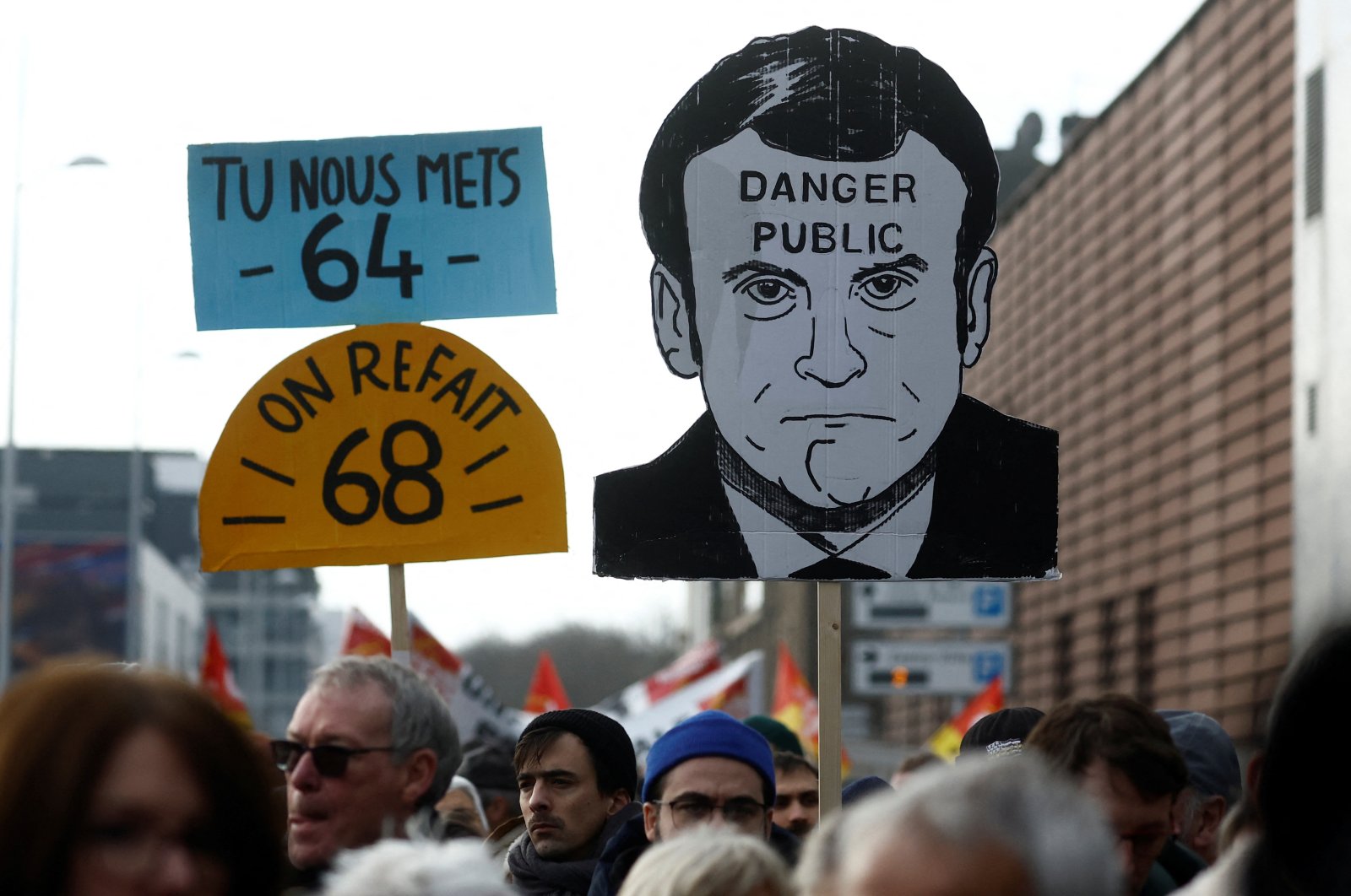 Protesters hold a placard depicting French President Emmanuel Macron, Saint-Nazaire, France, Jan. 31, 2023. (Reuters Photo)