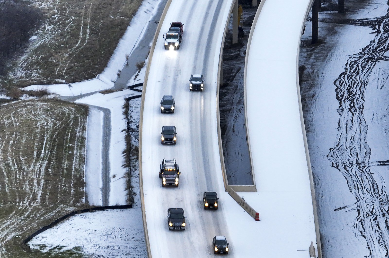 An icy mix covers Highway 114 in Roanoke, Texas. Dallas and other parts of North Texas are under a winter storm warning through Wednesday, Jan.23, 2023. (AP Photo)