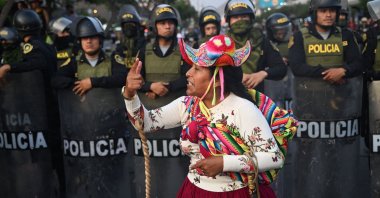 A protester gestures in front of policemen in Lima, Peru, Jan. 31, 2023. (AFP Photo)