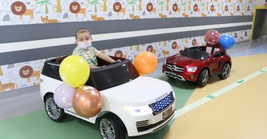 Children using ride-on cars are photographed at the oncology department of Erciyes University Hospital, Kayseri, Türkye, Feb, 1, 2023. (AA Photo)
