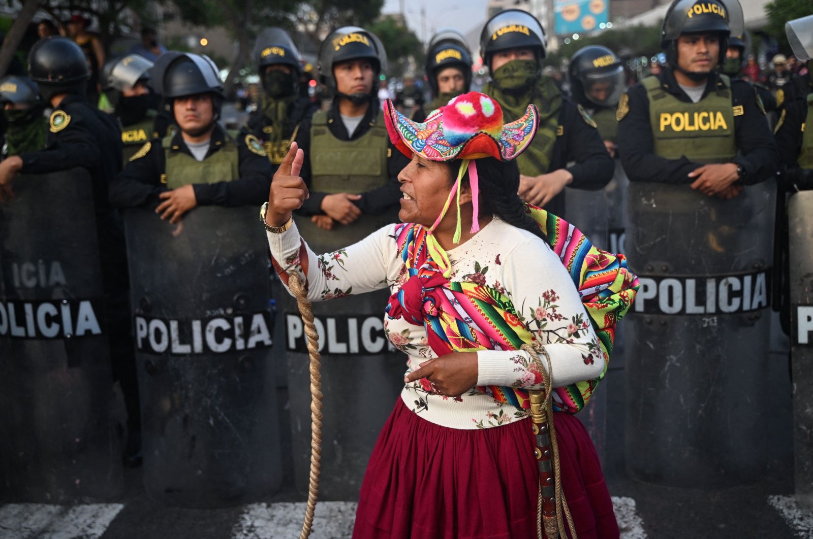 A protester gestures in front of policemen in Lima, Peru, Jan. 31, 2023. (AFP Photo)