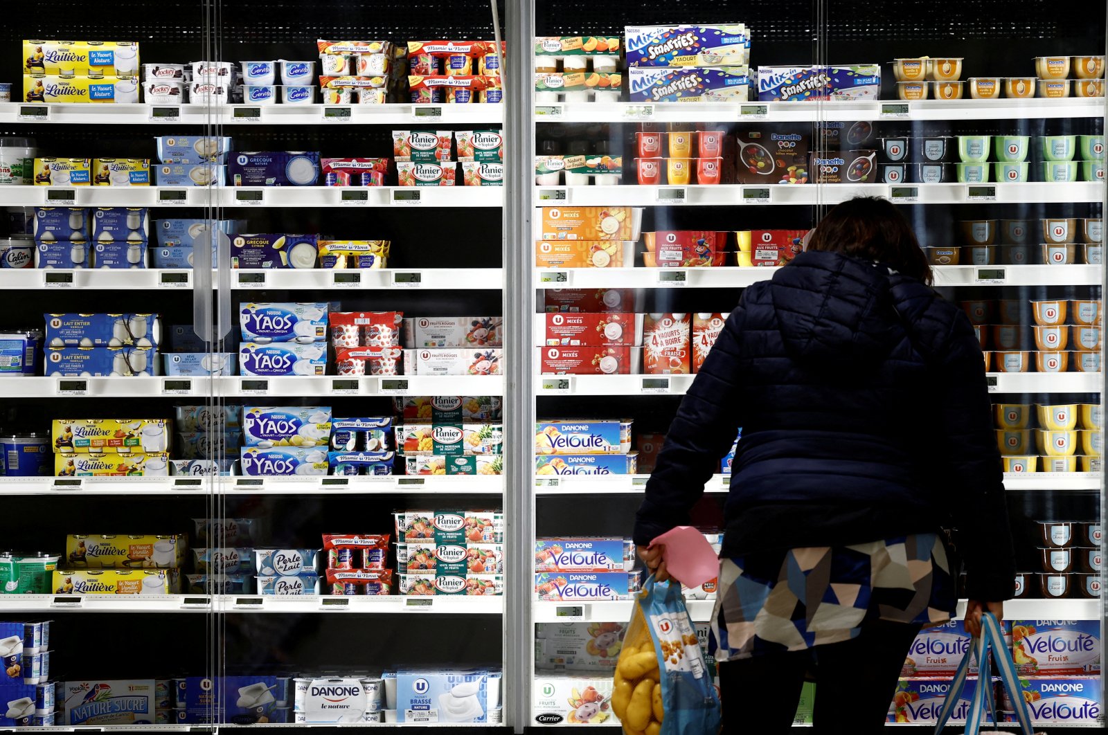 A woman looks at dairy products in a supermarket in La Verrie, France, Dec. 9, 2022. (Reuters Photo)